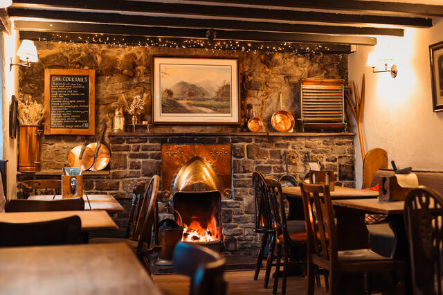 Rustic cosy fireplace and pub seating
